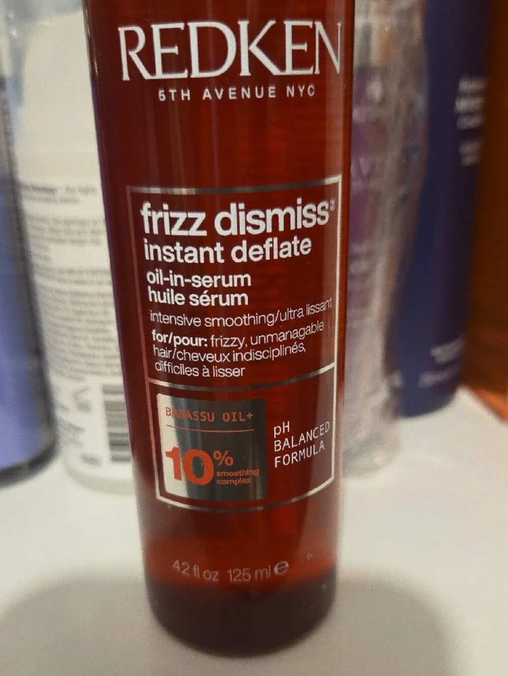 Redken Frizz Dismiss Instant Deflate Oil-In-Serum — amber red bottle